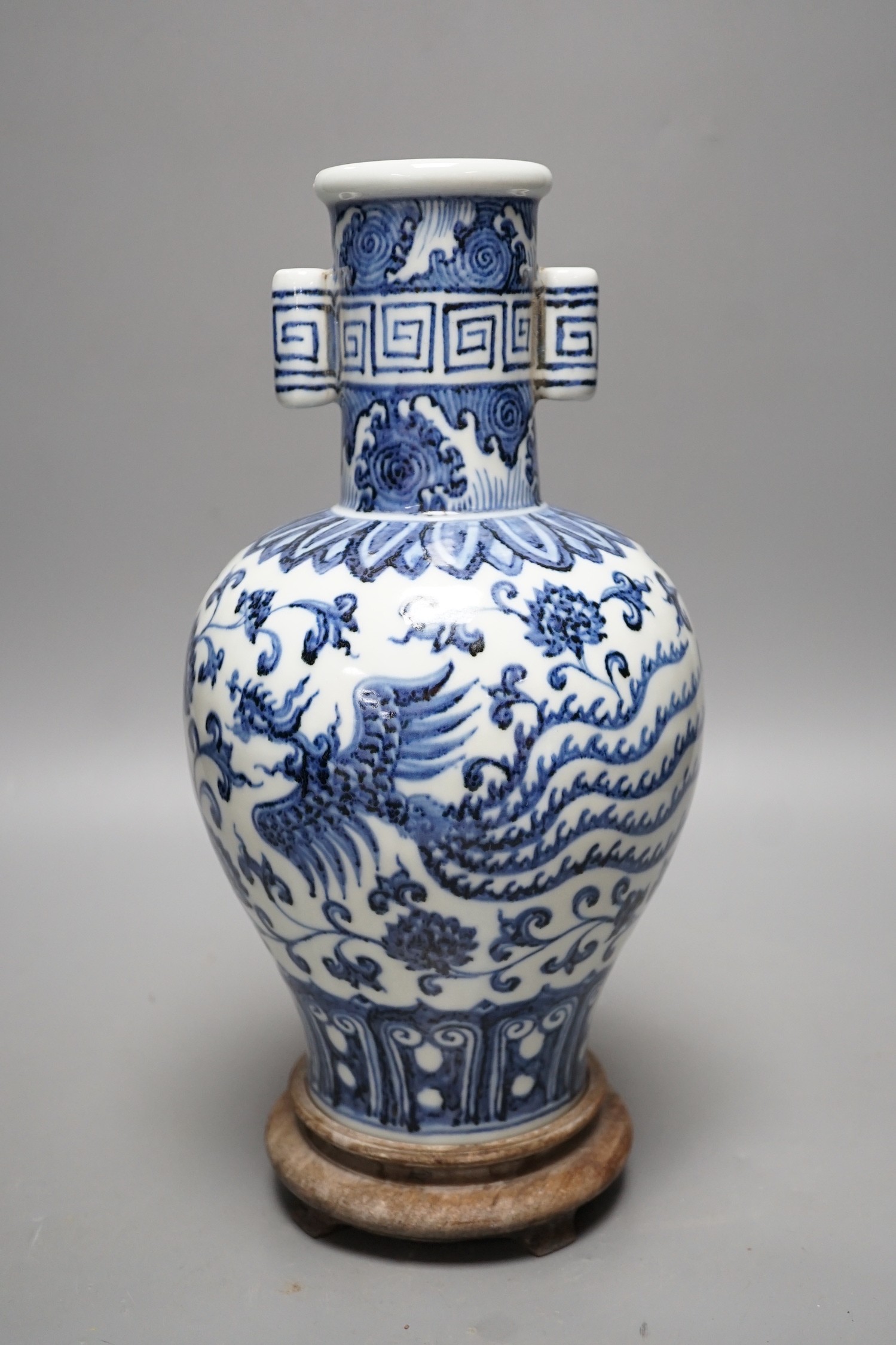 A Chinese blue and white vase on stand, 34cms high